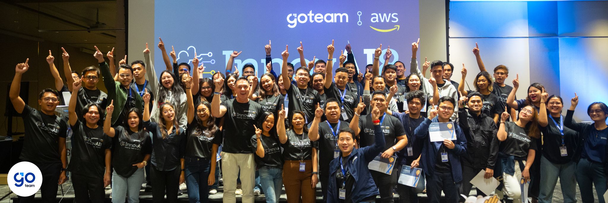InnovAI8 Summit participants celebrating together on stage