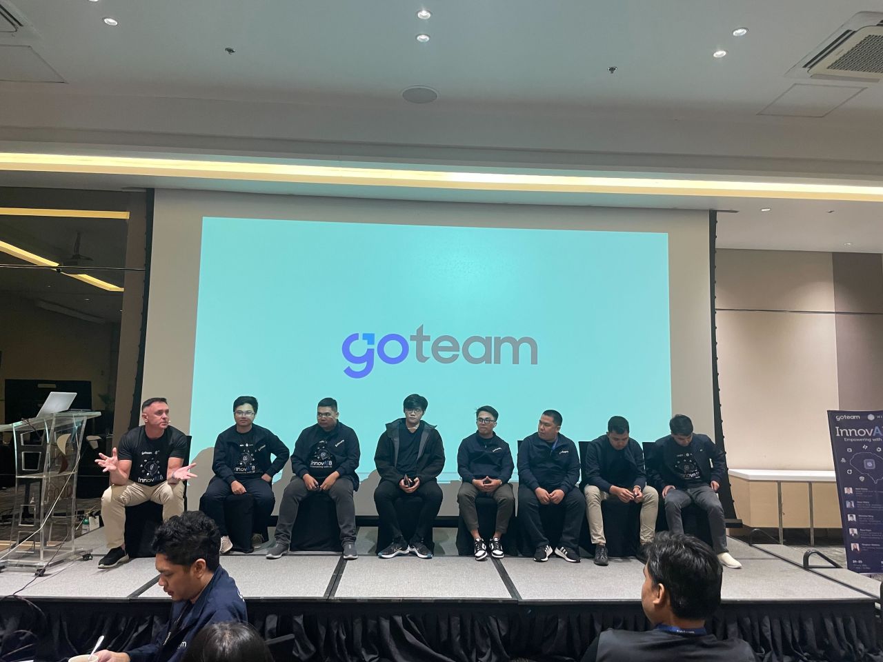 GoTeam AI talk panel seated on stage in front of the audience